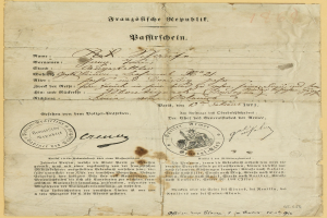 Gelblicher deutscher Regierungsbrief mit rundem schwarzumrandetem Stempel und schwarzer Tintenbeschriftung.
