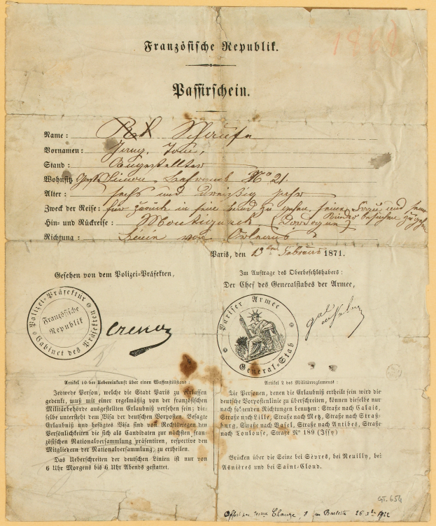 Ein altes, gelbliches Dokument mit einem kreisförmigen, schwarz umrandeten Stempel, das schwarze Text enthält, wahrscheinlich ein Brief der deutschen Regierung.