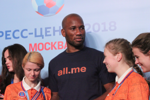 Gruppe von Menschen auf einer Bühne mit Medaillen, im Hintergrund ein Banner der FIFA-Weltmeisterschaft 2018 mit einem Fußball.